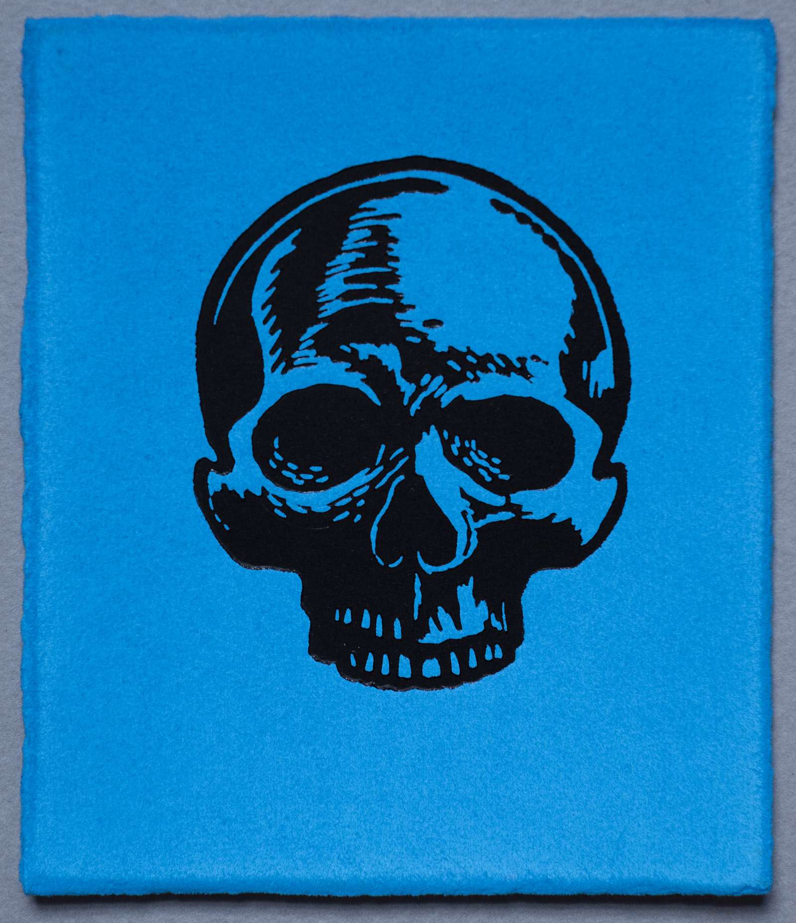 Small Skull, Lino Print on Turquoise Cyan hand painted Somerset Paper. by Miles Glyn Art